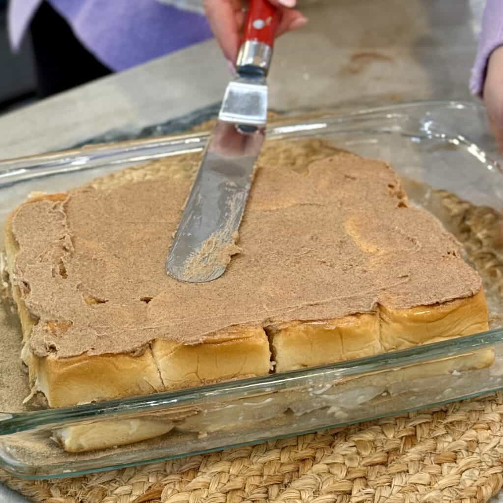 Spreading top layer of the mixture onto the sliders.