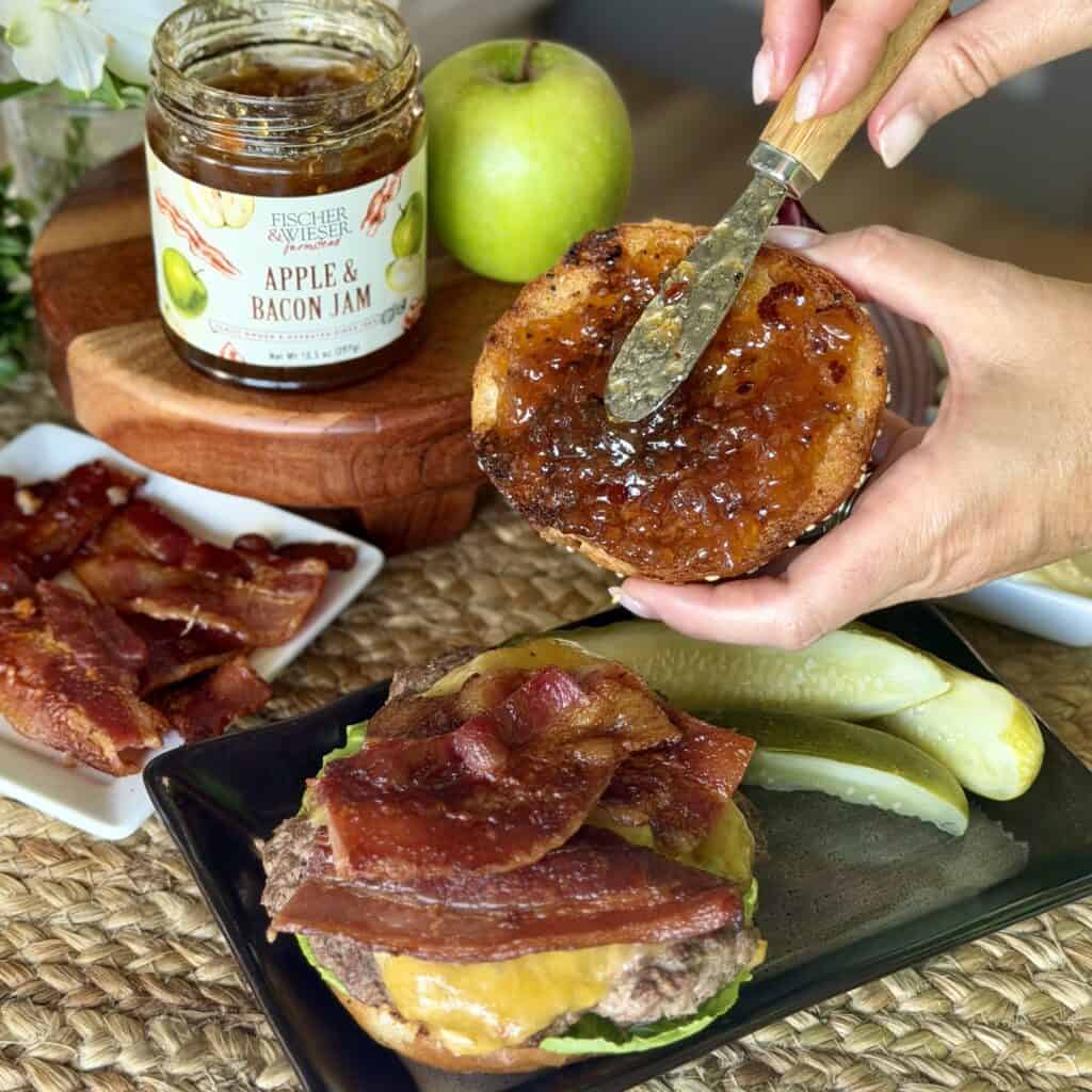 Spreading jam on a burger.