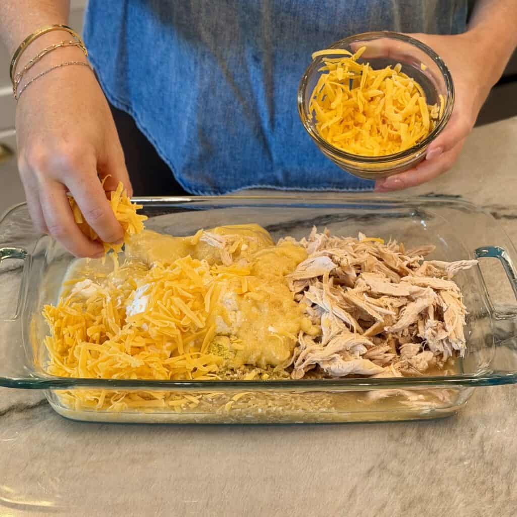 Adding cheese to the pan.