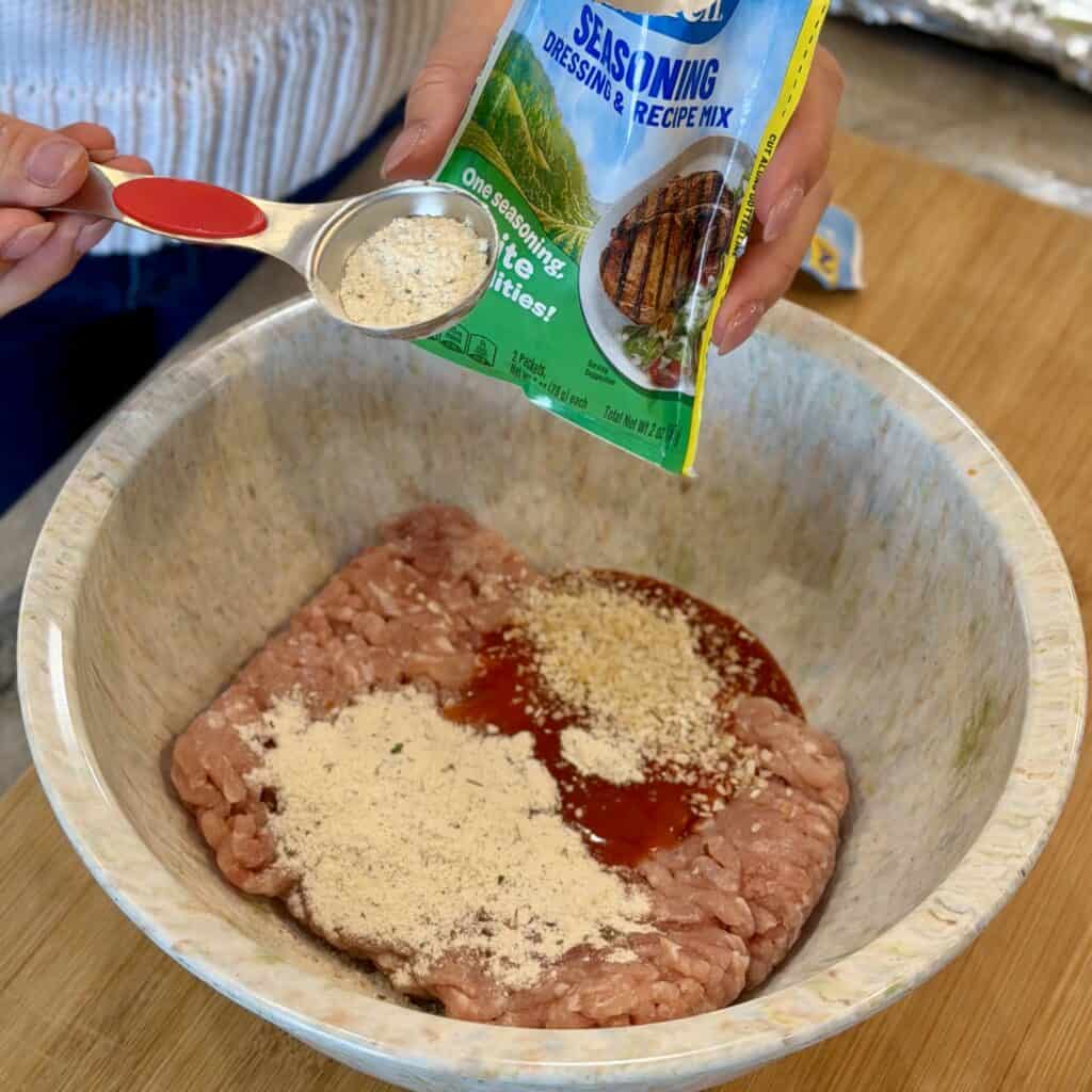 Adding seasoning to the bowl.