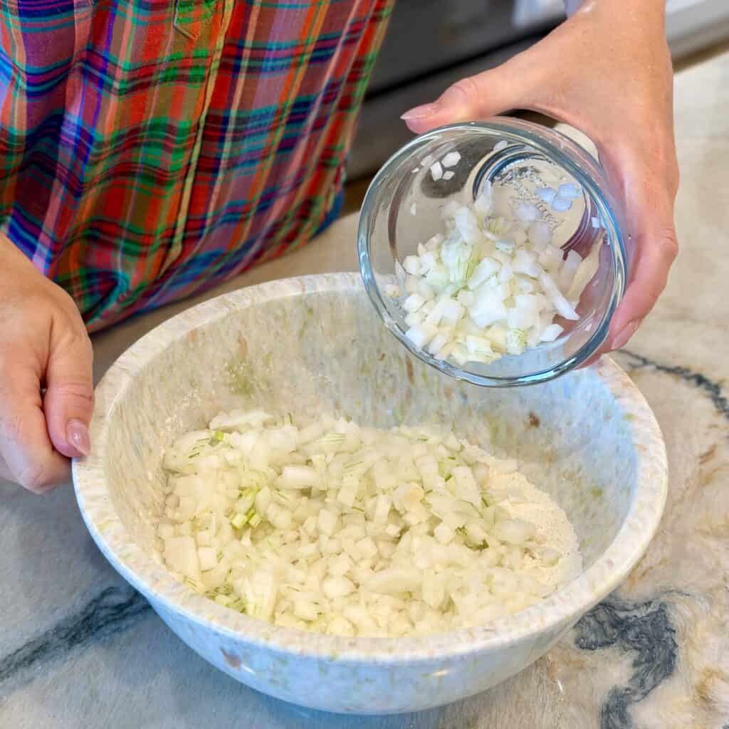 Adding the flour to the bowl.
