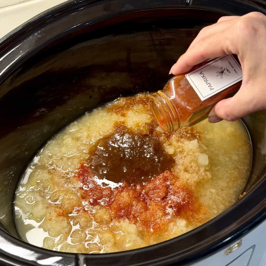 Adding seasonings to the pot.