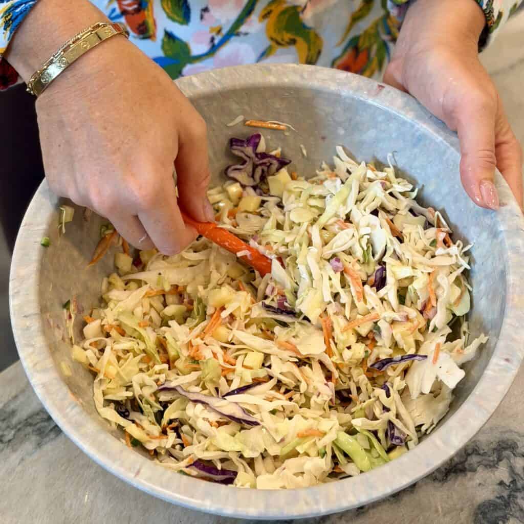 Mixing the Coleslaw together.