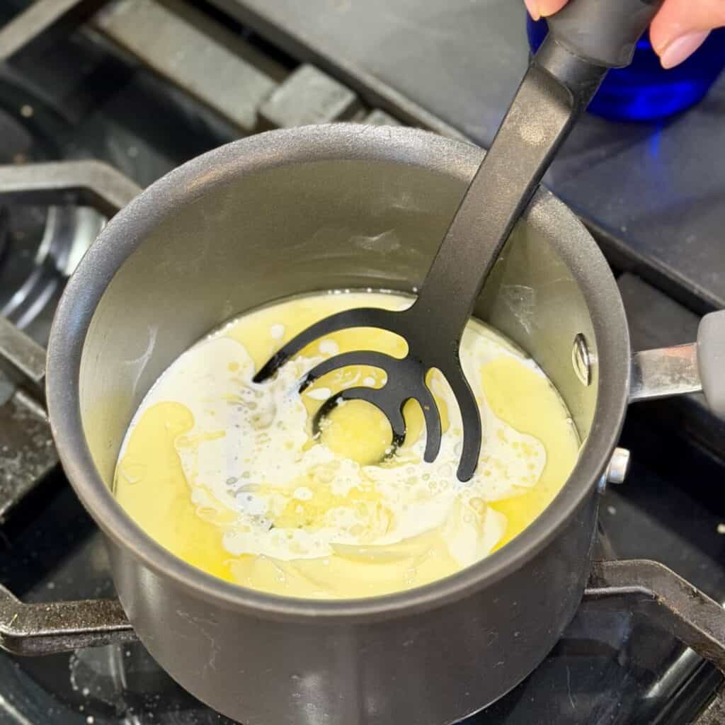 Stirring butter in the pan.