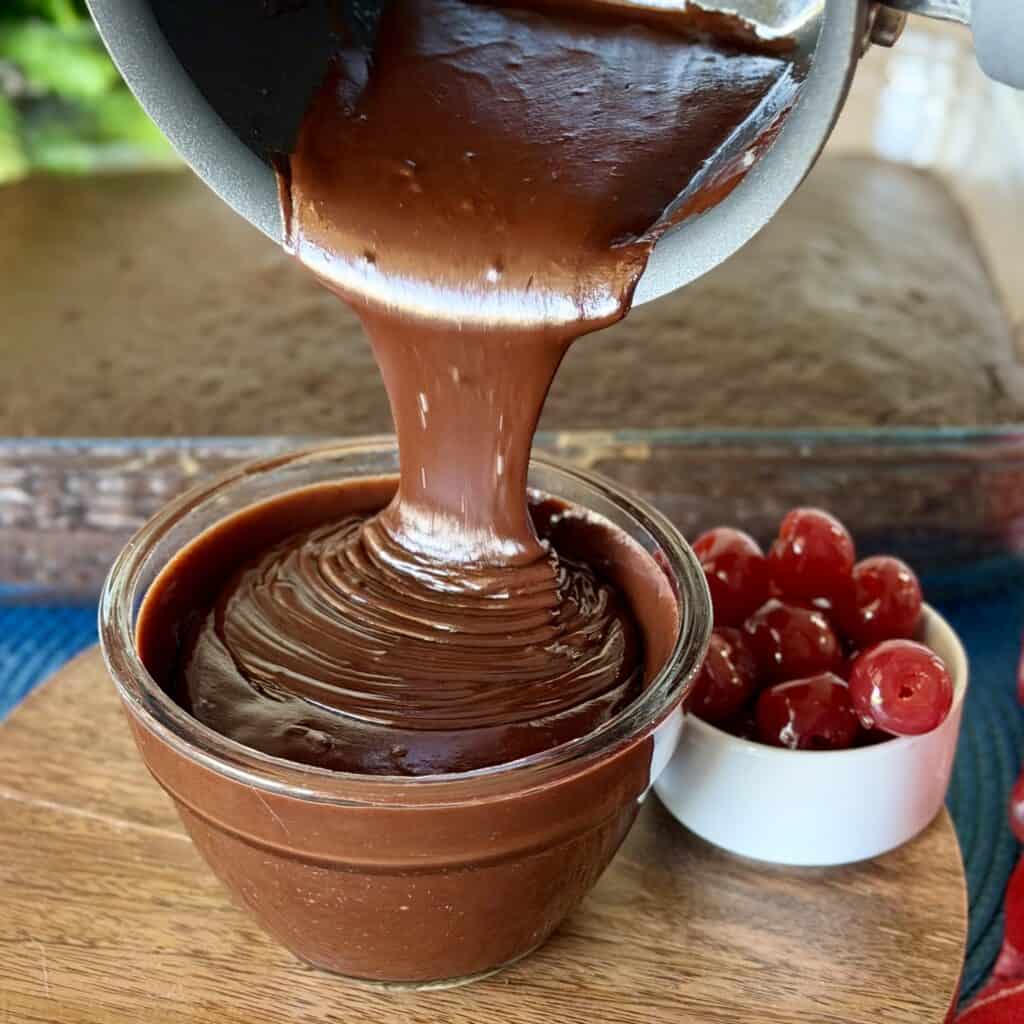 Pouring chocolate sauce into a bowl.