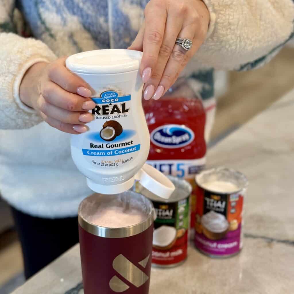 Adding coconut cream to the shaker.