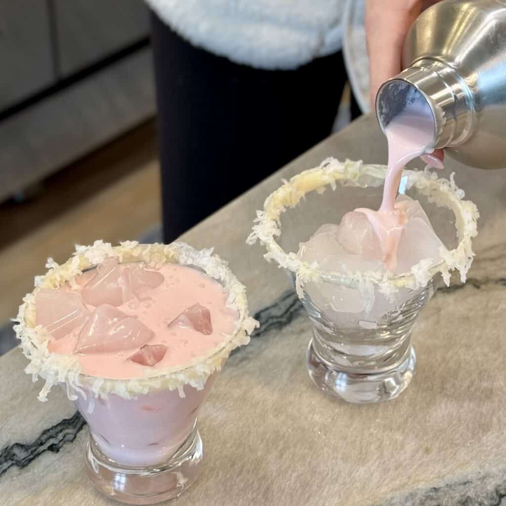 Adding drink mixture into the glass cups.