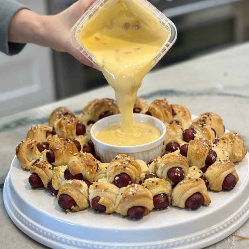 Adding queso cheese into the bowl.
