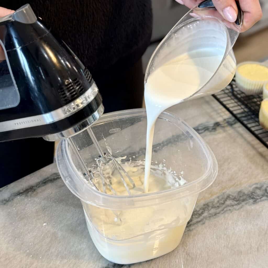 Adding cream to the bowl.