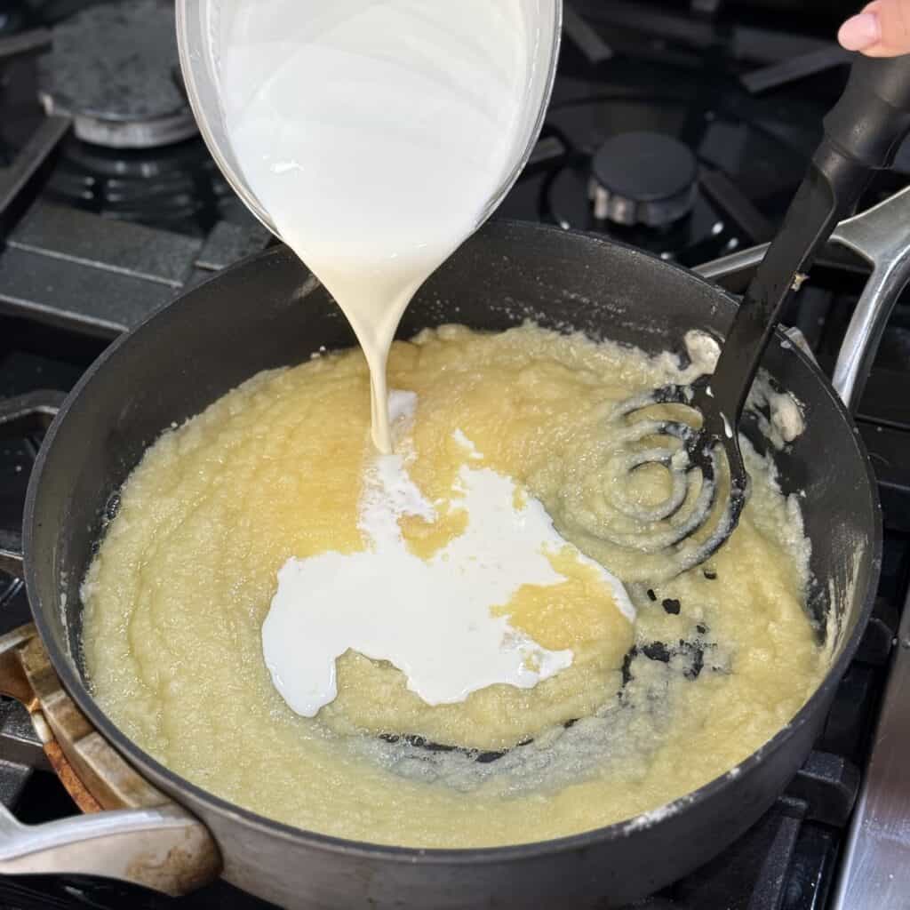 Adding cream to the pan.
