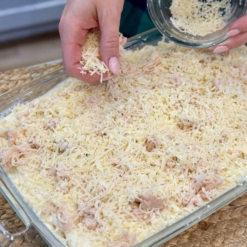 Topping the pan off with cheese.