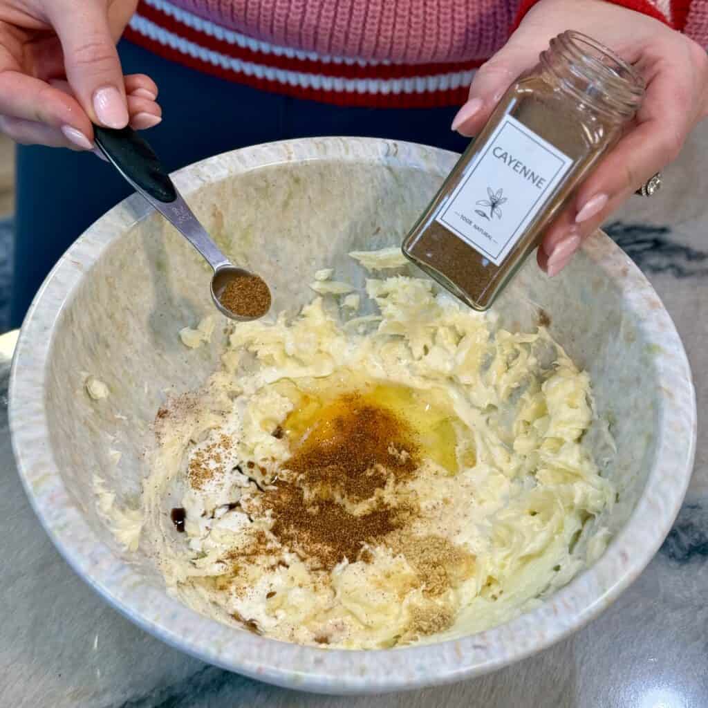 Adding seasoning to the bowl.