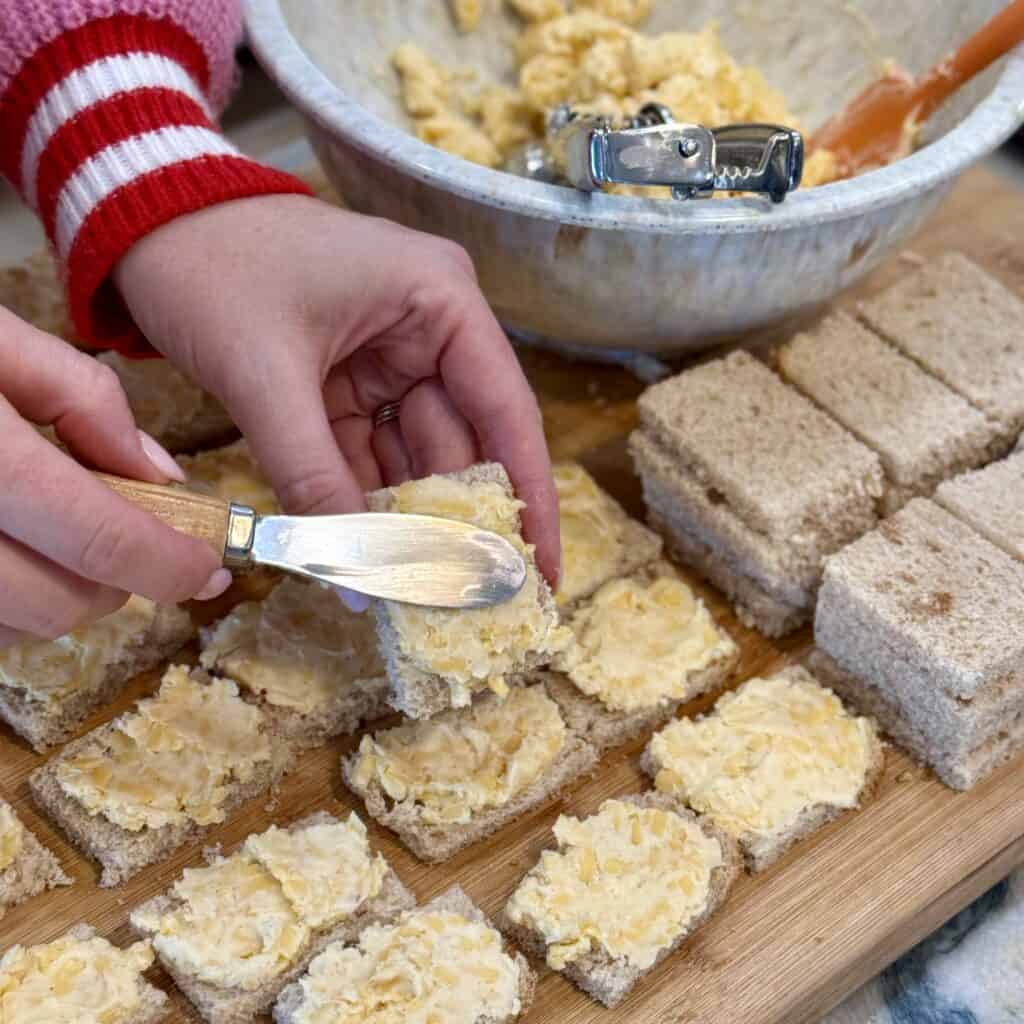Adding cheese mixture on the bread.