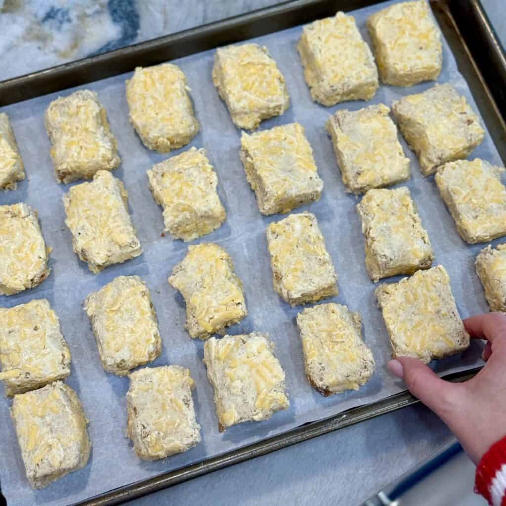 Adding cheese bites to the pan.