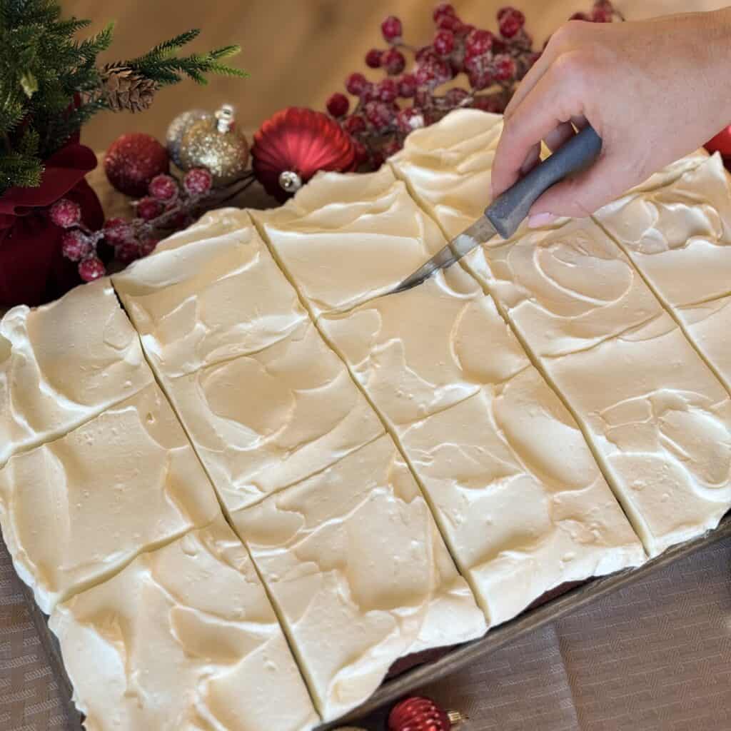 Slicing the Red Velvet Sheet Cake.
