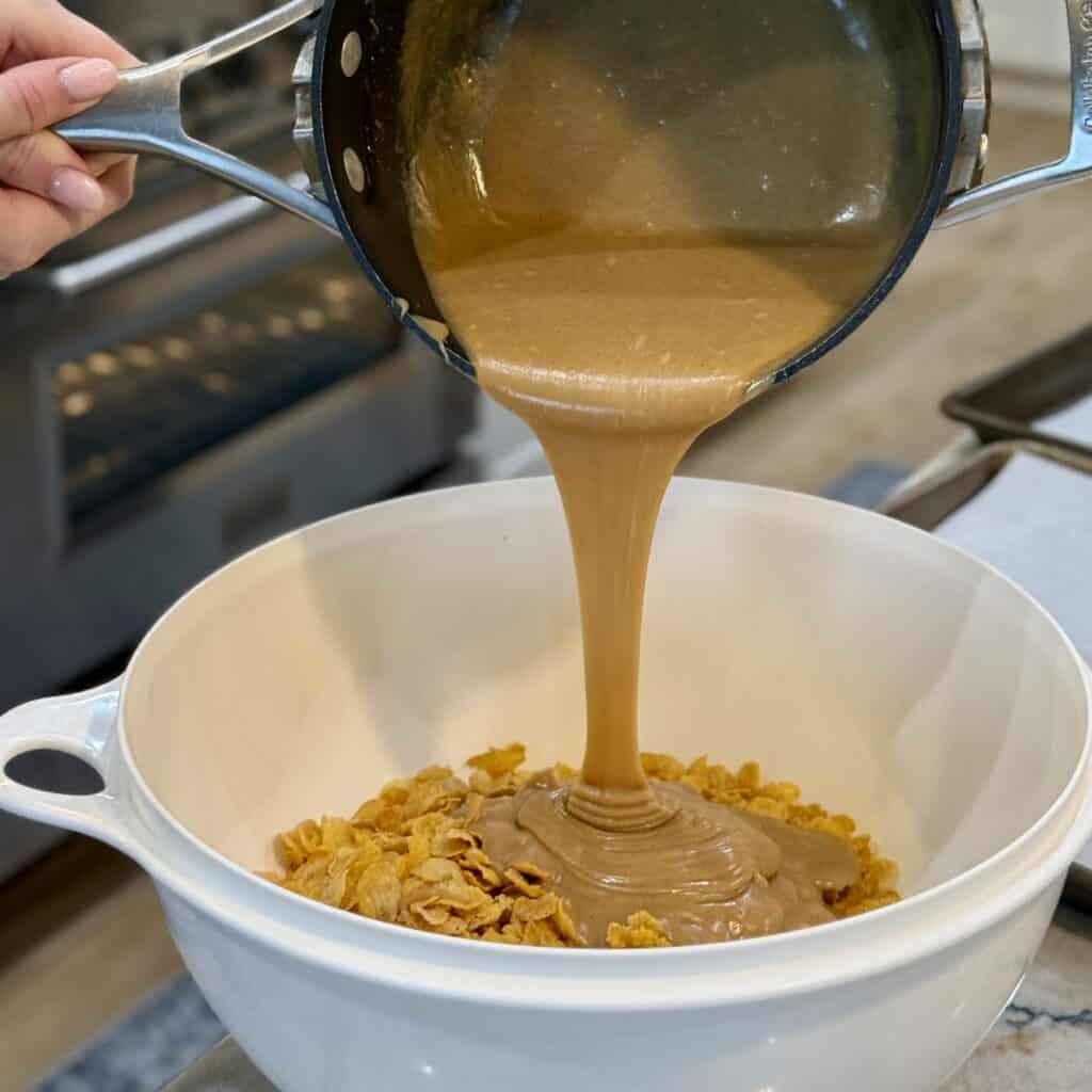 Adding batter to the corn flakes.