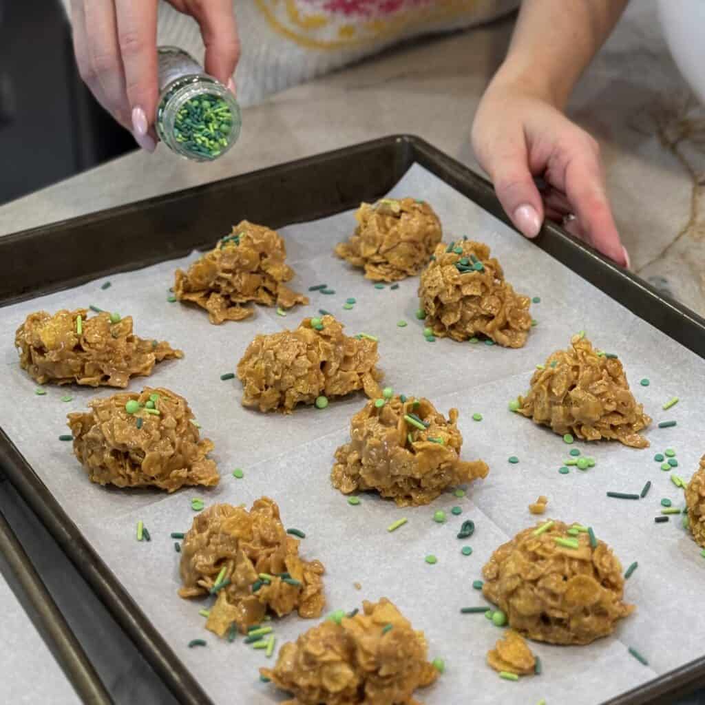 Adding the sprinkles to the Cornflake candy.