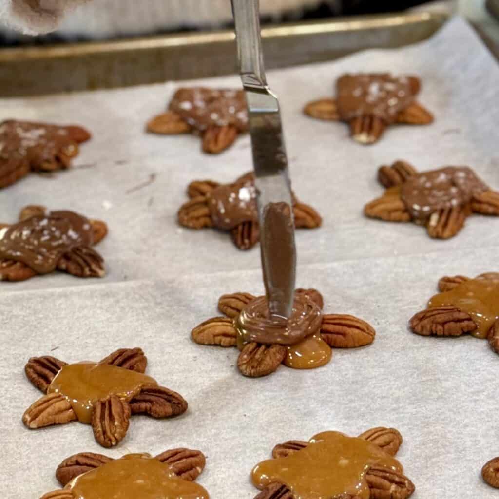 Adding chocolate to pecans.