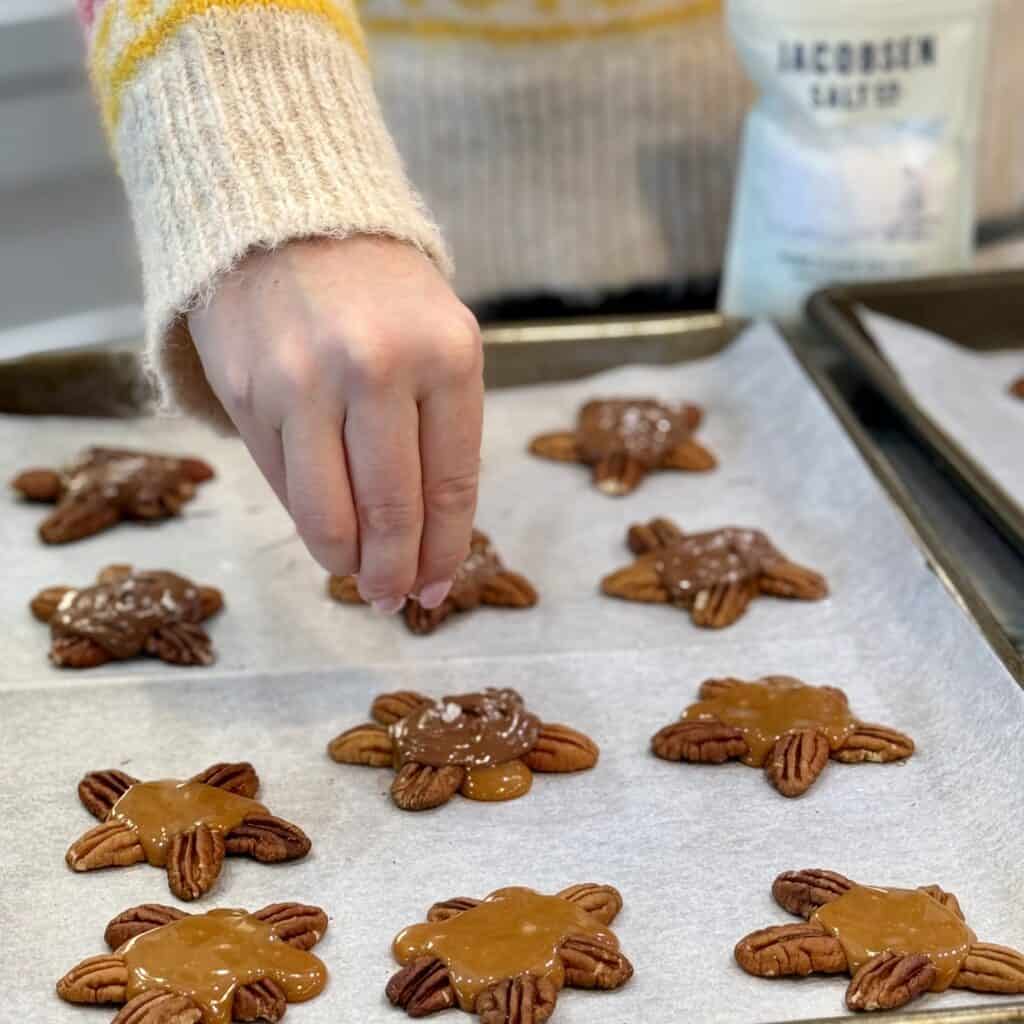 Adding salt to the Chocolate Turtles.