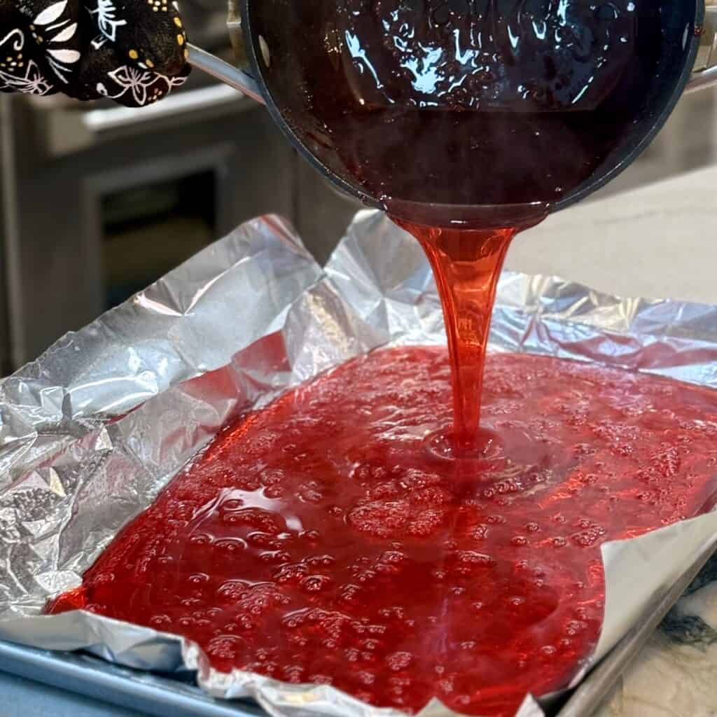 Adding Hard candy liquid to the pan.