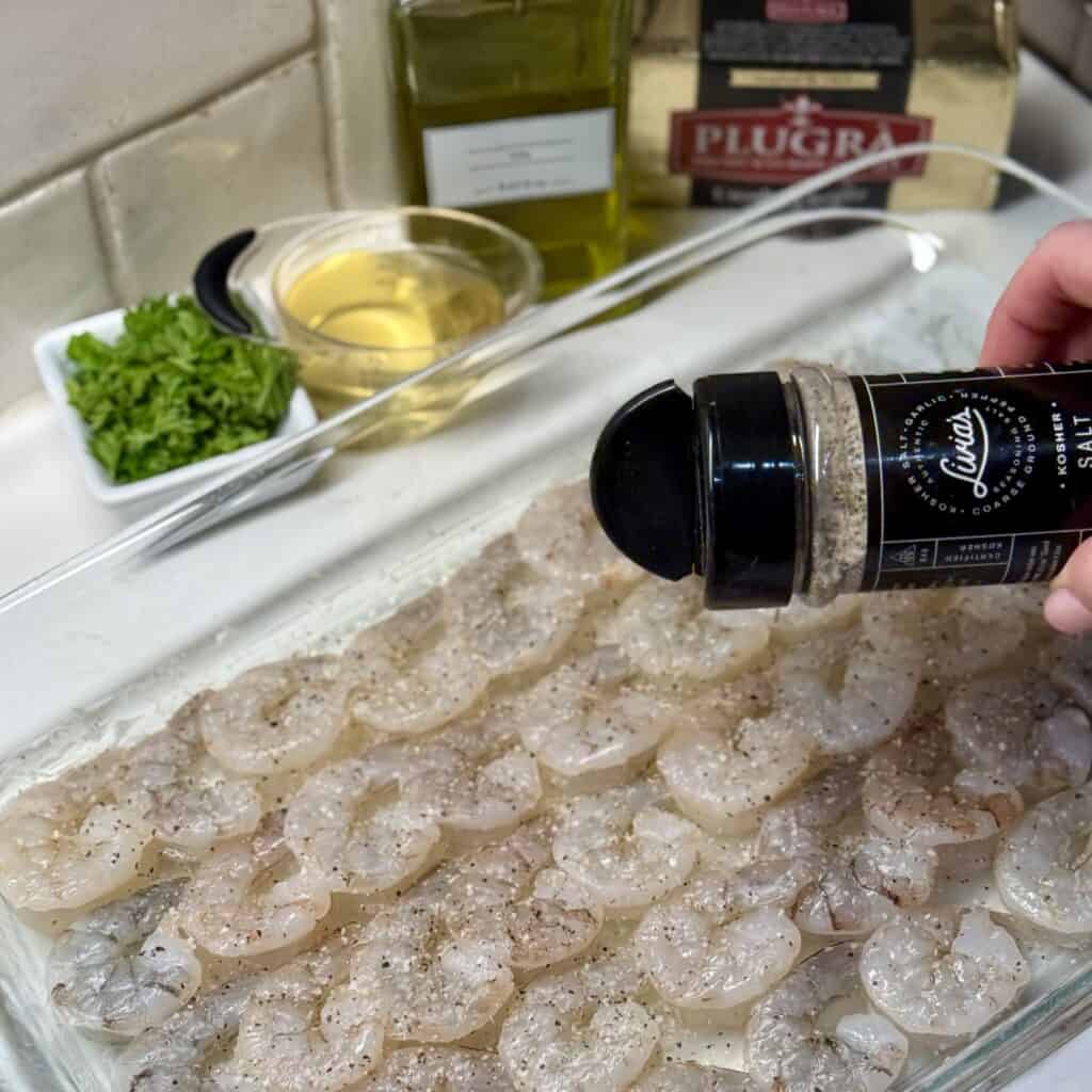 Seasoning the shrimp.