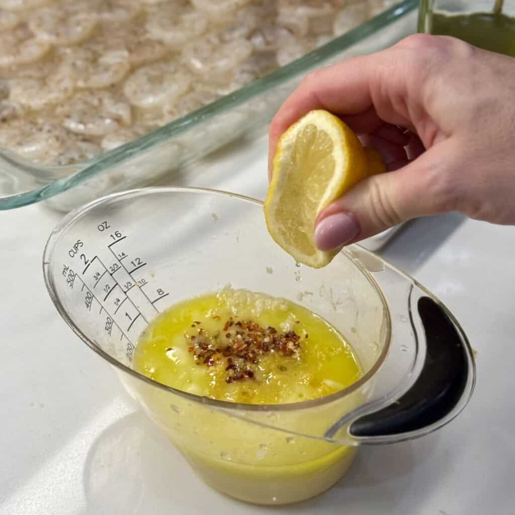 Adding squeezed lemon to the cup.