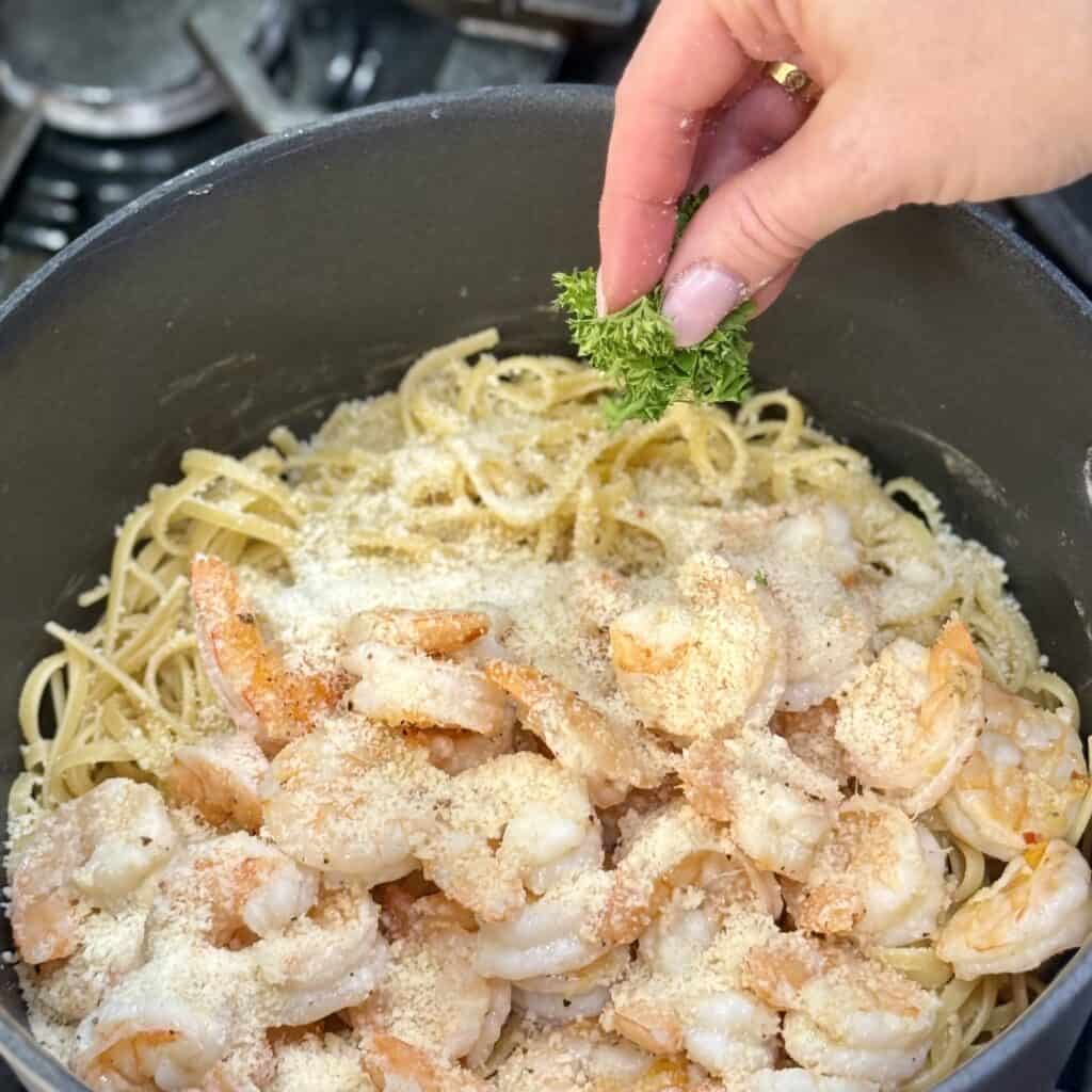 Adding parsley into the pan.