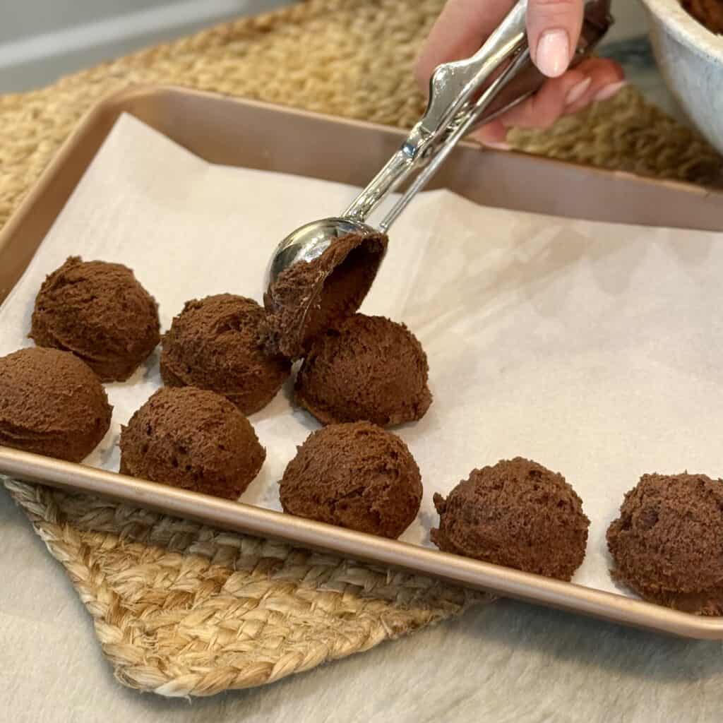 Scooping the dough onto the parchment paper.