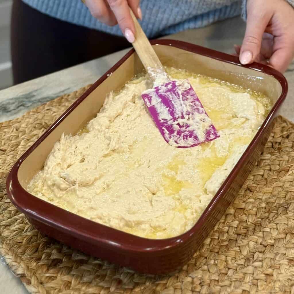 Spreading biscuit mixture in the pan.