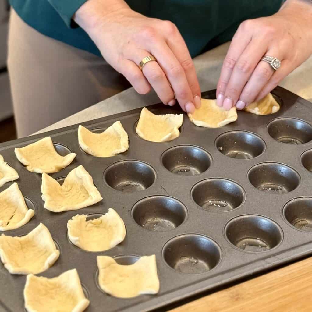 Adding dough pieces in the pan.