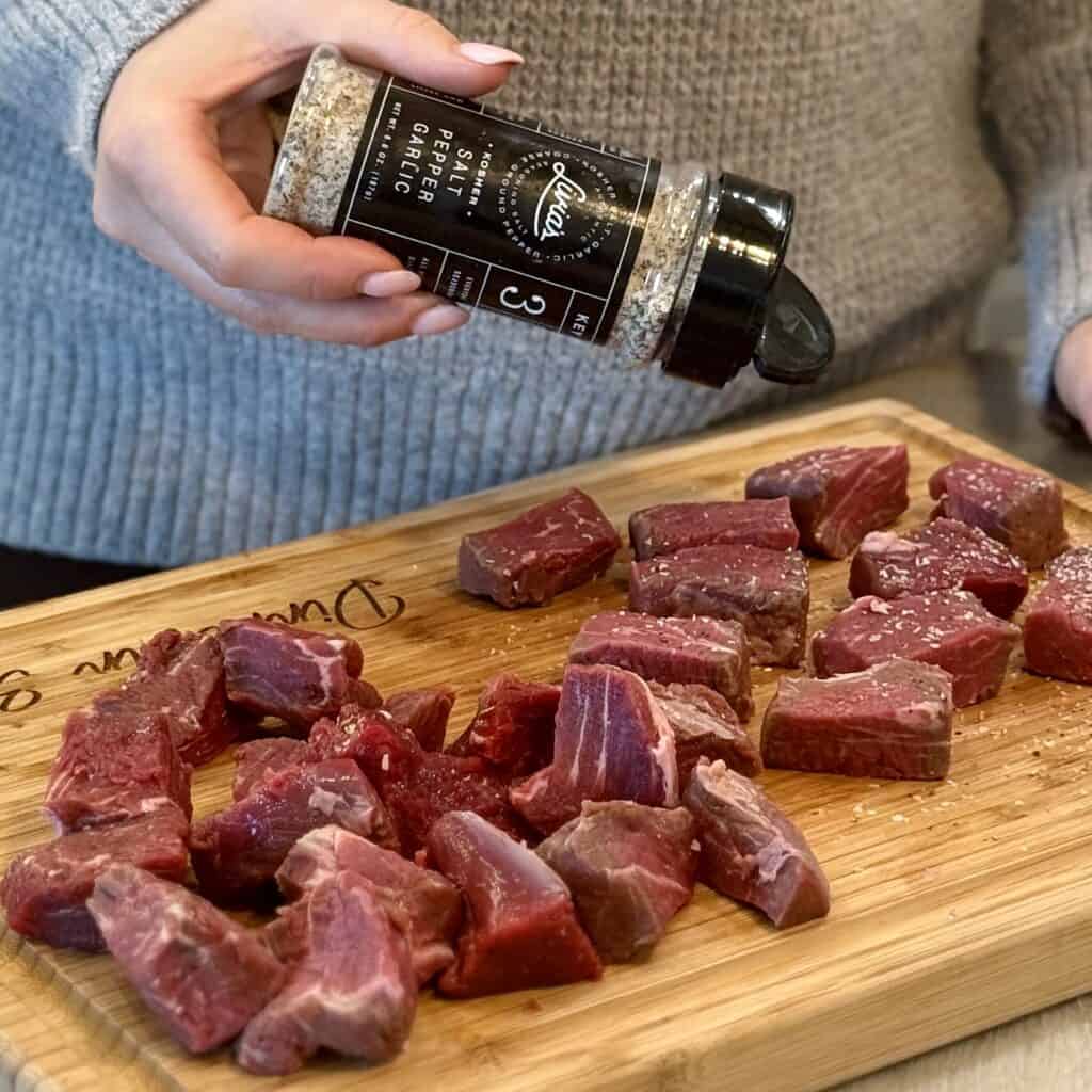 Seasoning the tenderloin steak.