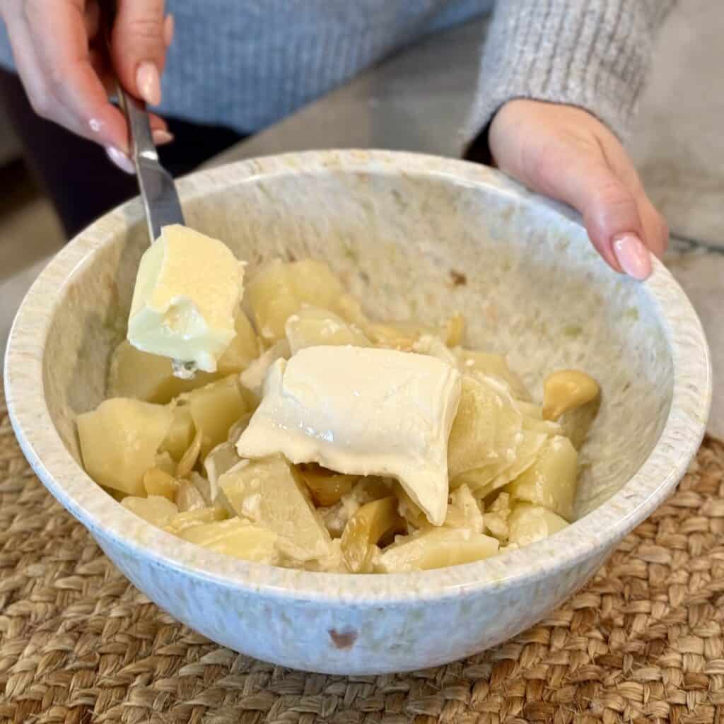 Adding butter to the bowl.