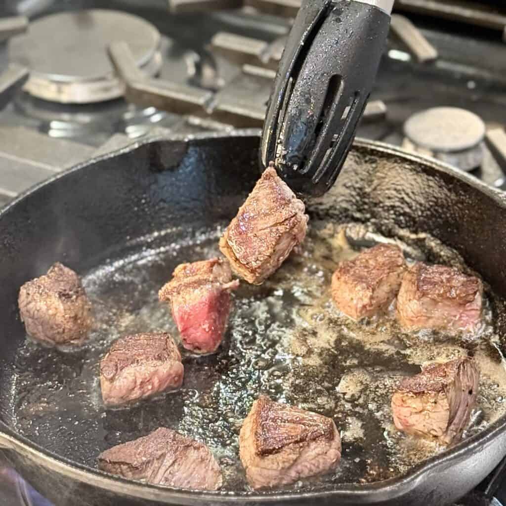 Frying the beef tips.