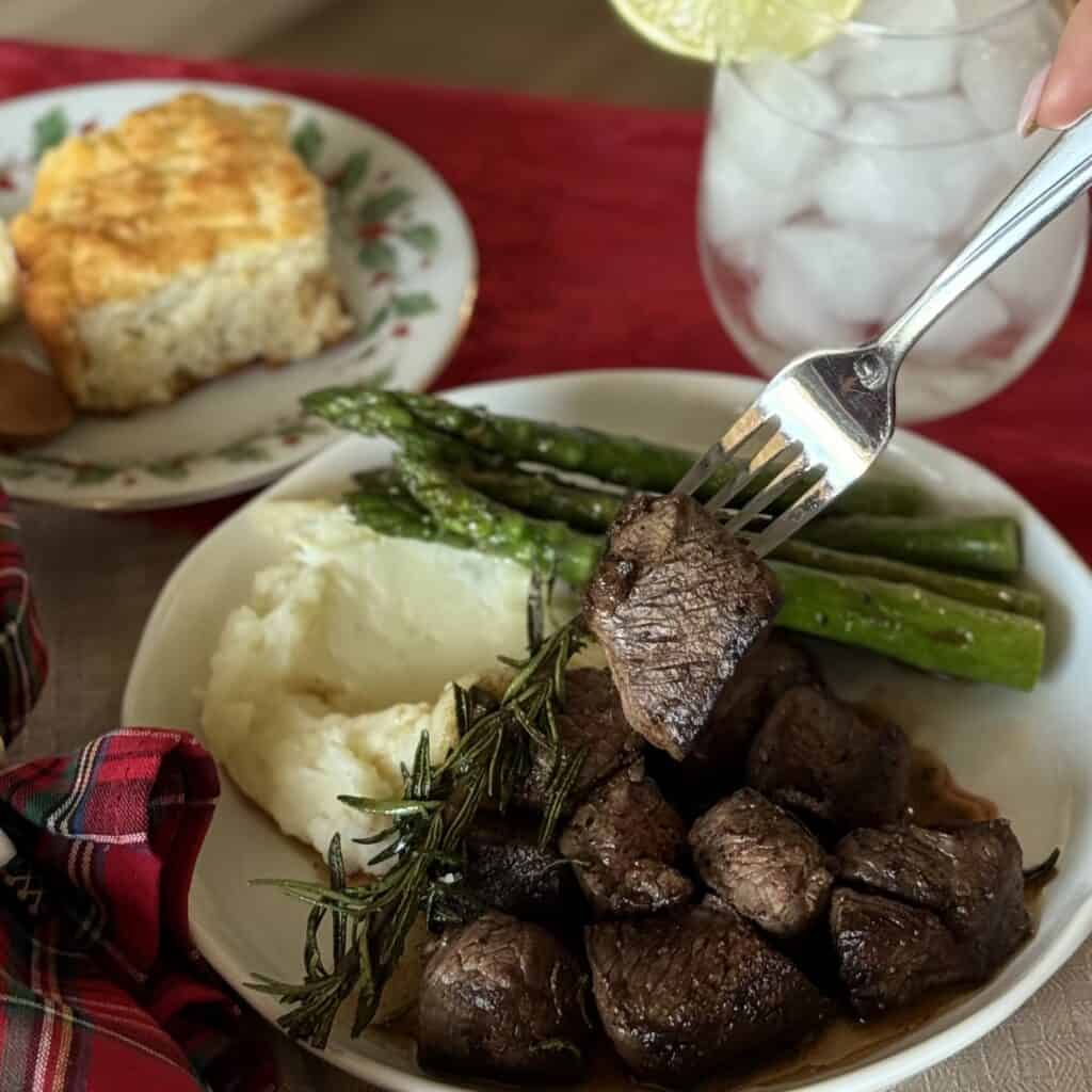A plate of Beef Tenderloin Tips and sides.