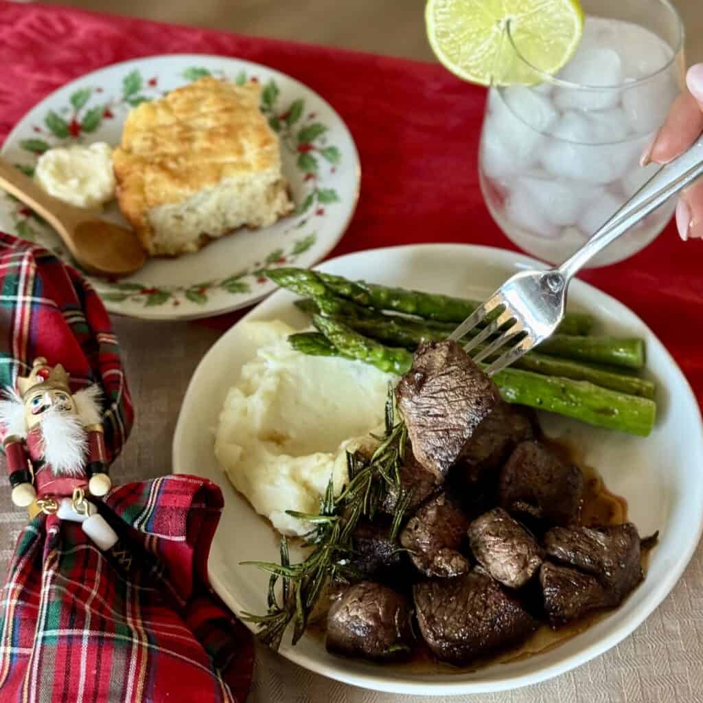 A plate of Beef Tenderloin Tips and sides.