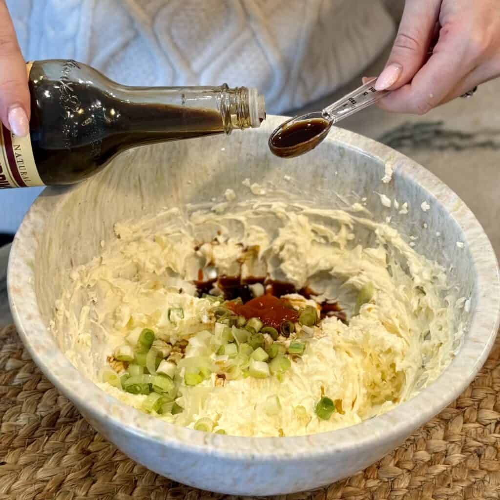 Adding sauce to the bowl.