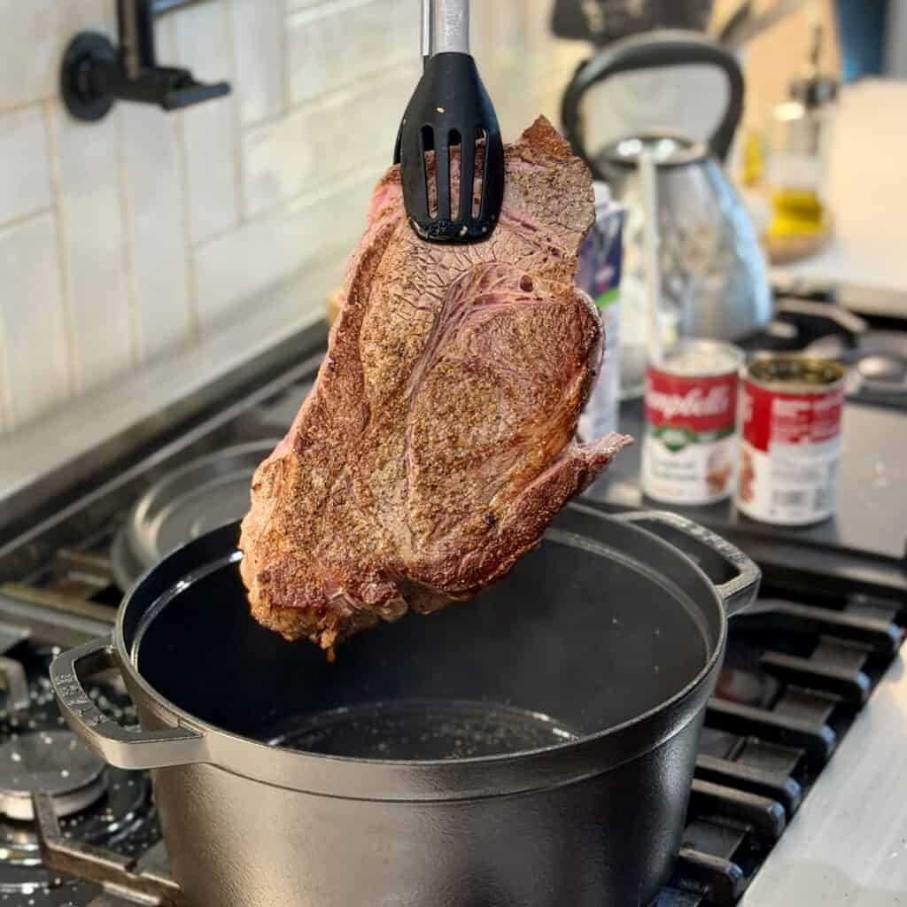 Adding the beef to the pot.