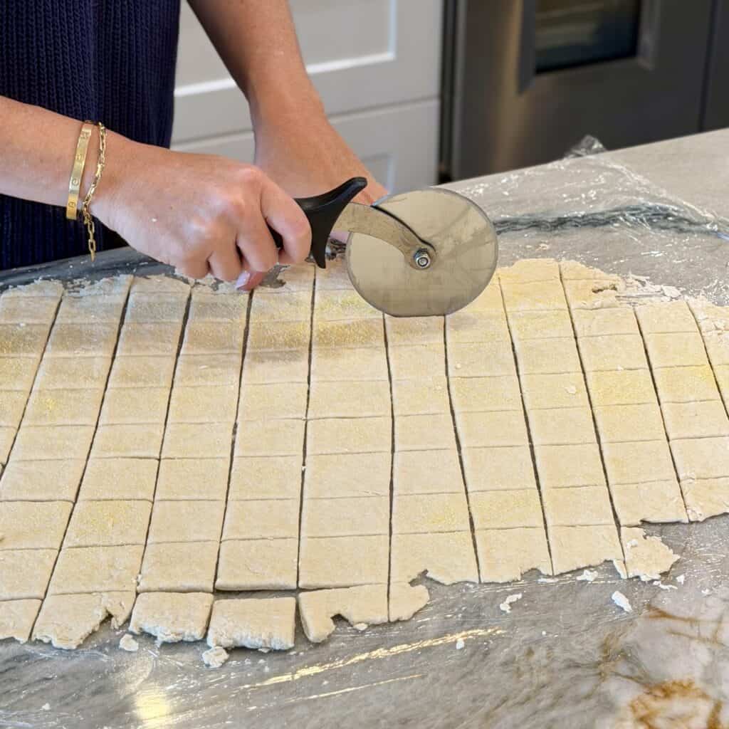 Cutting the dough into squares.