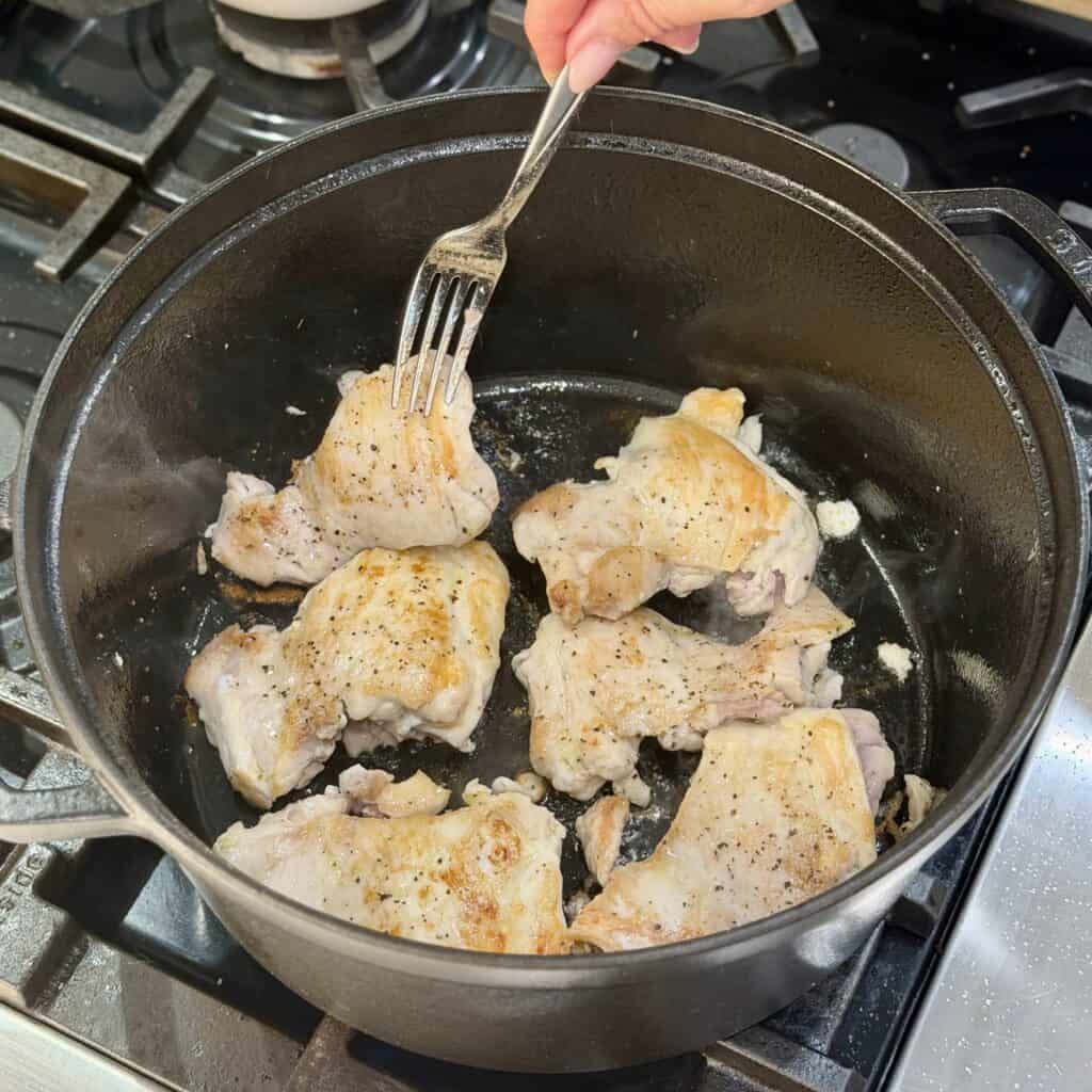 Frying the chicken in the pan.