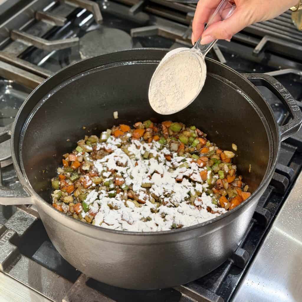 Adding flour to the pan.