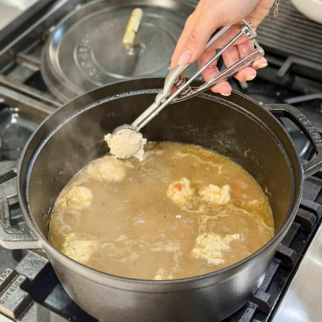 Adding biscuits to the pan.