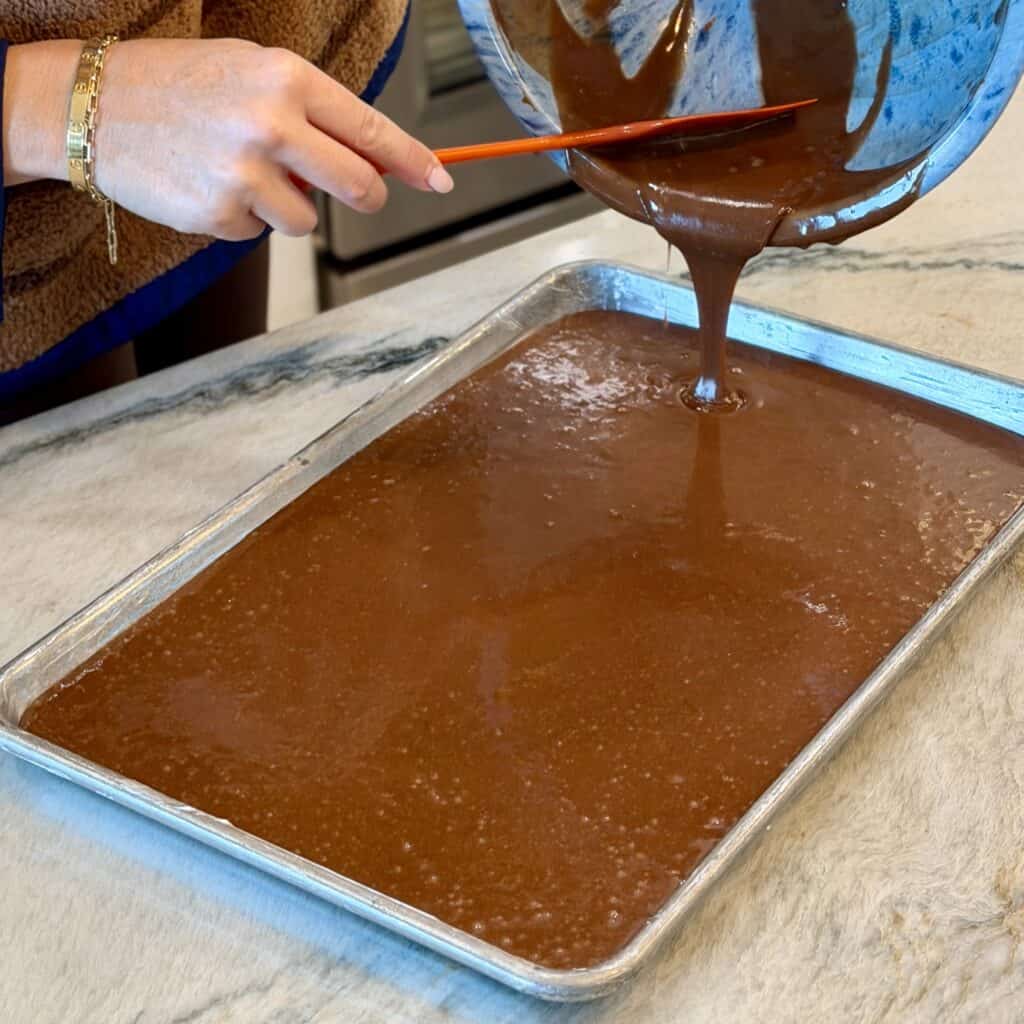 Add batter to a pan for texas sheet cake.